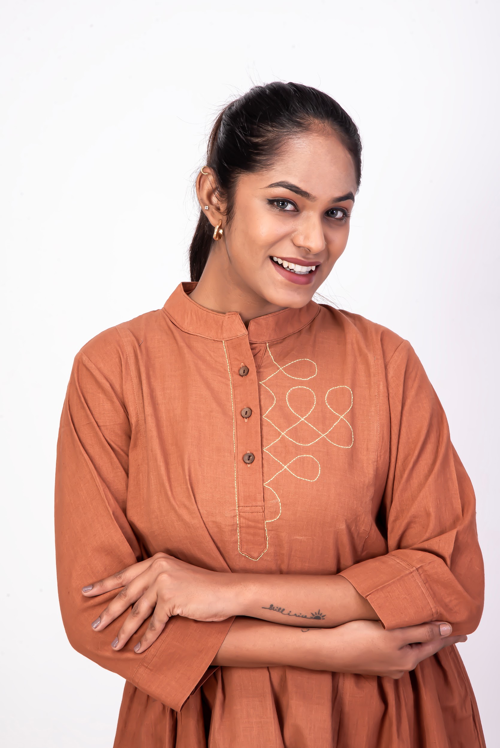 Stylish Dark Pomo Orange handwoven cotton dress featuring a mandarin collar, relaxed princess-cut silhouette, and handcrafted kolam embroidery created using naturally dyed organic fabric.